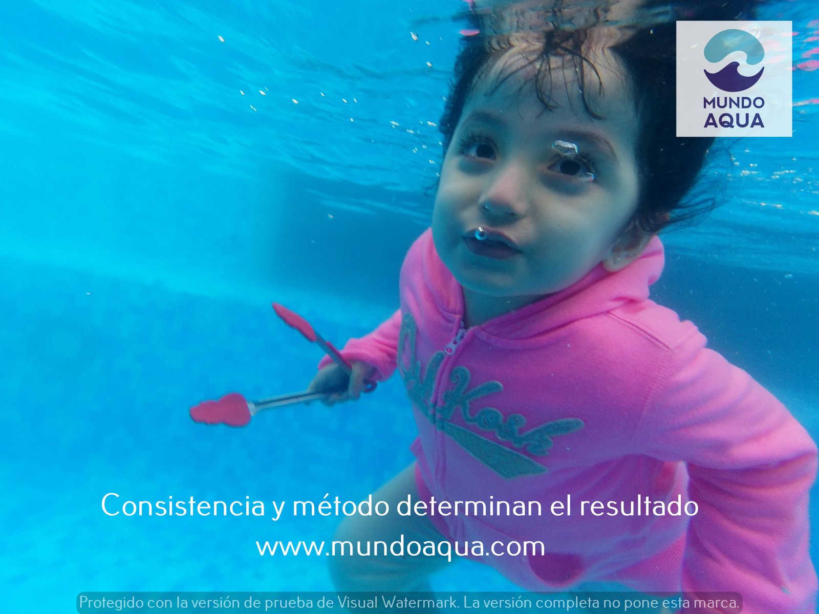 Baby swimming comfortably under the surface applying Aquatic Shielding